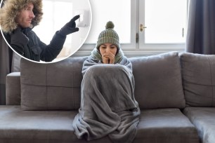 woman sitting on a couch with a blanket, with a person in gloves turning the heat on